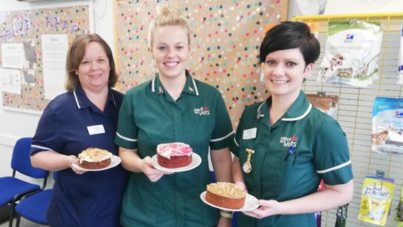 Staff showing off their baked cakes
